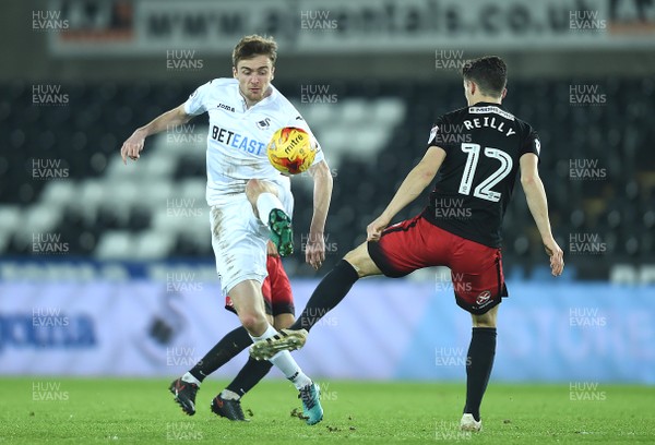 240117 - Swansea City Under 21s v Coventry - Checkatrade Trophy - Ryan Blair of Swansea City is tackled by Callum Reilly of Coventry