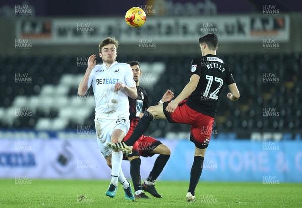 240117 - Swansea City Under 21s v Coventry - Checkatrade Trophy - Ryan Blair of Swansea City is tackled by Callum Reilly of Coventry