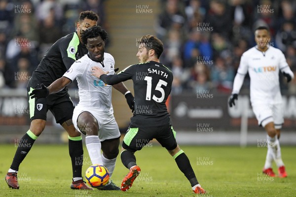 251117 - Swansea City v AFC Bournemouth, Premier League - Wilfried Bony of Swansea City (centre) and Adam Smith of AFC Bournemouth (right) battle for the ball