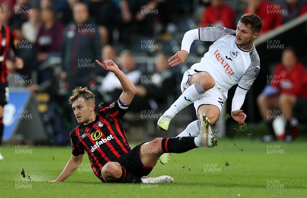 290823 - Swansea City v AFC Bournemouth - Carabao Cup - Liam Cullen of Swansea is tackled by David Brooks of Bournemouth 