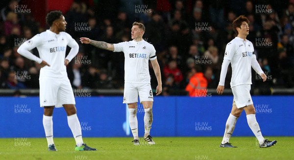 140117 - Swansea City v Arsenal - Premier League - Dejected Leroy Fer, Alfie Mawson and Ki Sung-Yueng of Swansea City by Chris Fairweather/Huw Evans Agency