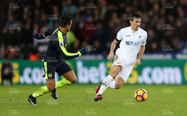 140117 - Swansea City v Arsenal - Premier League - Jack Cork of Swansea City is put under pressure by Alexis Sanchez of Arsenal by Chris Fairweather/Huw Evans Agency