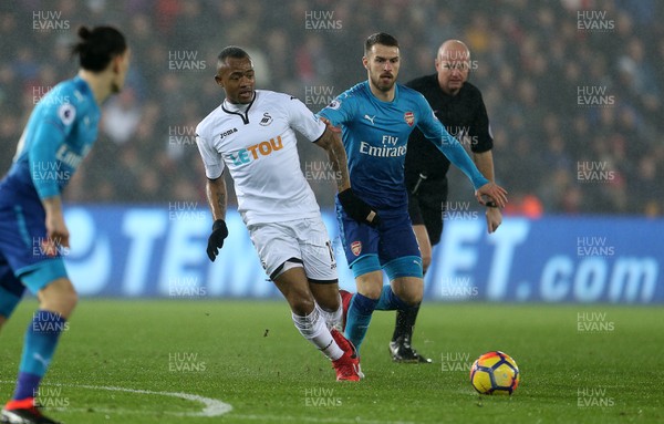 300118 - Swansea City v Arsenal - Premier League - Martin Olsson of Swansea City is challenged by Aaron Ramsey of Arsenal