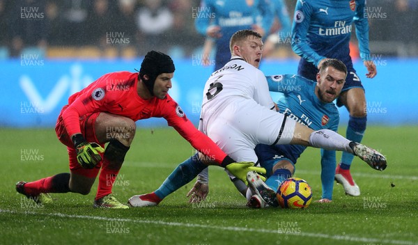 300118 - Swansea City v Arsenal - Premier League - Alfie Mawson of Swansea City scrambles for the ball with Petr Cech and Aaron Ramsey of Arsenal