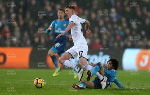 300118 - Swansea City v Arsenal - Premier League - Sam Clucas of Swansea City is tackled by Mohamed Elneny of Arsenal