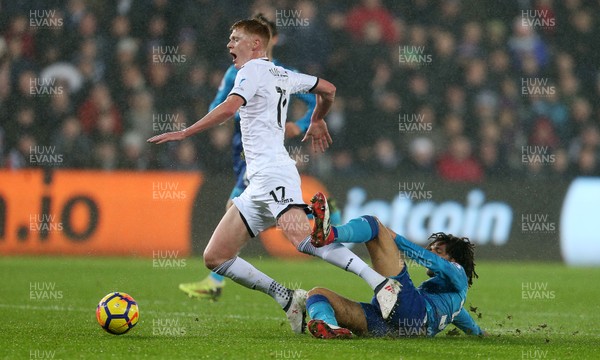300118 - Swansea City v Arsenal - Premier League - Sam Clucas of Swansea City is tackled by Mohamed Elneny of Arsenal