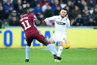 261218 - Swansea City v Aston Villa - SkyBet Championship - Matt Grimes of Swansea City is tackled by Yannick Bolasie of Aston Villa