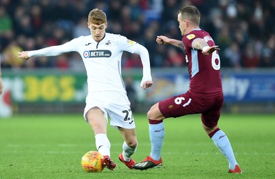 261218 - Swansea City v Aston Villa - SkyBet Championship - Jay Fulton of Swansea City is tackled by Glenn Whelan of Aston Villa