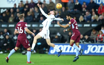 261218 - Swansea City v Aston Villa - SkyBet Championship - Oliver McBurnie of Swansea City and Ahmed Elmohamady of Aston Villa compete