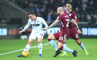 261218 - Swansea City v Aston Villa - SkyBet Championship - Connor Roberts of Swansea City is tackled by Alan Hutton of Aston Villa