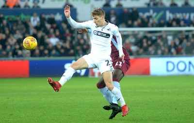 261218 - Swansea City v Aston Villa - SkyBet Championship - Jay Fulton of Swansea City is tackled by Yannick Bolasie of Aston Villa