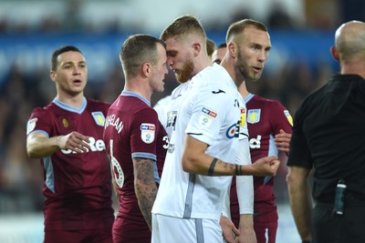 261218 - Swansea City v Aston Villa - SkyBet Championship - Glenn Whelan of Aston Villa and Oliver McBurnie of Swansea City square up