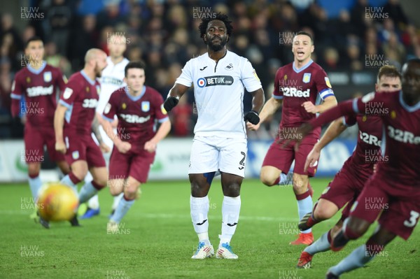 261218 - Swansea City v Aston Villa - SkyBet Championship - Wilfried Bony of Swansea City looks dejected as he misses a shot from the penalty spot as James Chester of Aston Villa celebrates in the background