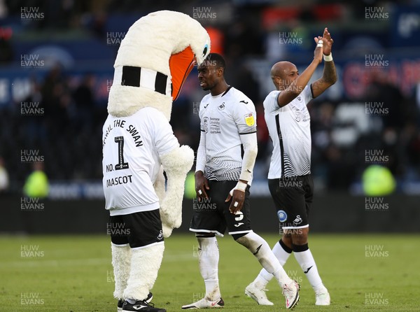 220521 - Swansea City v Barnsley, Sky Bet Championship Play Off Semi Final, Second Leg - Marc Guehi of Swansea City and Andre Ayew of Swansea City celebrate with mascot Cyril the Swan as Swansea beat Barnsley to reach the Championship Play Off Final