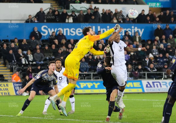 291219 - Swansea City v Barnsley, Sky Bet Championship - Barnsley goalkeeper Samuel Radlinger punches the ball clear as Andre Ayew of Swansea City looks to head at goal