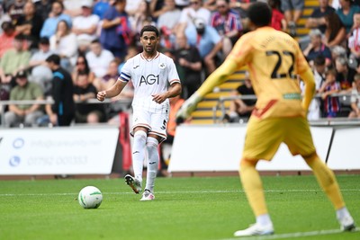 080826 - Swansea City v Birmingham City - Carabao Cup First Round - Ben Cabango of Swansea City passes the ball to Lawrence Vigouroux of Swansea City