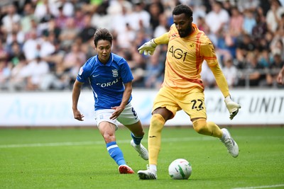 080826 - Swansea City v Birmingham City - Carabao Cup First Round - Paik Seung-Ho of Birmingham City challenges Lawrence Vigouroux of Swansea City for the ball