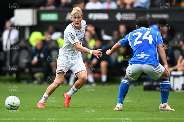 080826 - Swansea City v Birmingham City - Carabao Cup First Round - Melker Widell of Swansea City is challenged by Tomoki Iwata of Birmingham City