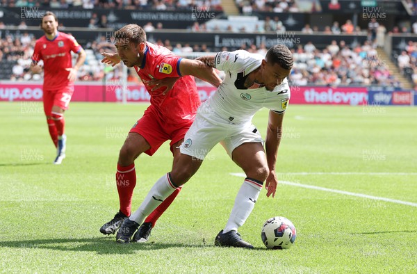 060822 - Swansea City v Blackburn Rovers, Sky Bet Championship - Joel Latibeaudiere of Swansea City and Harry Pickering of Blackburn Rovers compete for the ball