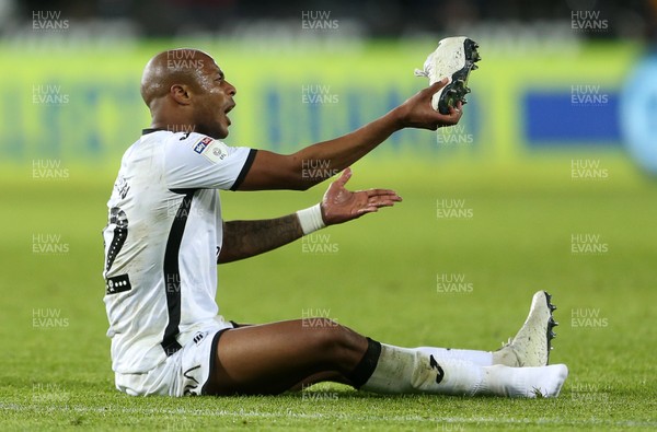 111219 - Swansea City v Blackburn Rovers - SkyBet Championship - A frustrated Andre Ayew of Swansea City shows his boot to the referee after missing a shot at goal