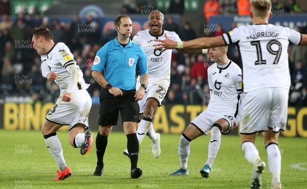 111219 - Swansea City v Blackburn Rovers - SkyBet Championship - Connor Roberts, Andre Ayew, Bersant Celina and Sam Surridge of Swansea City contest referee Jeremy Simpson's decision