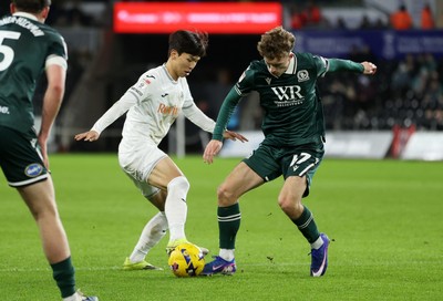 200126 - Swansea City v Blackburn Rovers - SkyBet Championship - Eom Ji-Sung of Swansea City is tackled by Aodhan Doherty of Blackburn Rovers 