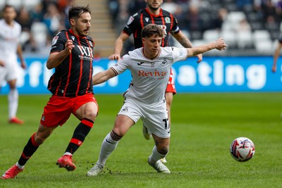 220225 - Swansea City v Blackburn Rovers - Sky Bet Championship - Goncalo Franco of Swansea City battles for the ball with Lewis Travis of Blackburn Rovers