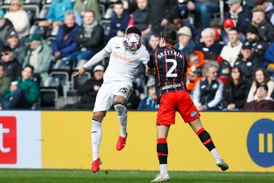 220225 - Swansea City v Blackburn Rovers - Sky Bet Championship - Myles Peart-Harris of Swansea City challenges for the aerial ball with Callum Brittain of Blackburn Rovers