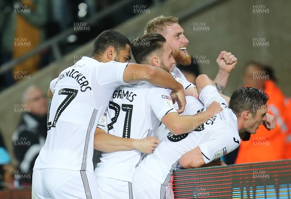 231018 - Swansea City v Blackburn Rovers, Sky Bet Championship - Team mates celebrate with Bersant Celina of Swansea City after he scores the third goal