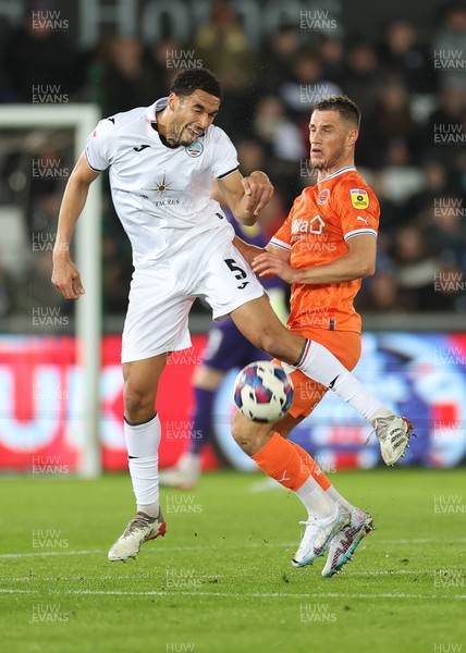 150223 - Swansea City v Blackpool, EFL Sky Bet Championship - Ben Cabango of Swansea City and Jerry Yates of Blackpool compete for the ball