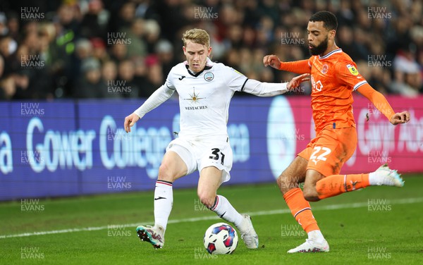 150223 - Swansea City v Blackpool, EFL Sky Bet Championship - Ollie Cooper of Swansea City and CJ Hamilton of Blackpool compete for the ball