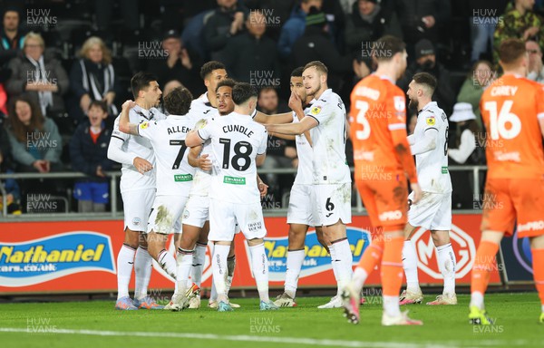 150223 - Swansea City v Blackpool, EFL Sky Bet Championship - Swansea players celebrate after Callum Connolly of Blackpool puts the ball in his own net to give Swansea their second goal