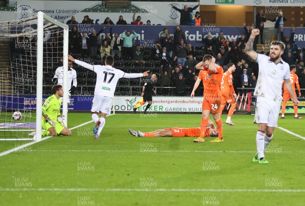 150223 - Swansea City v Blackpool, EFL Sky Bet Championship - Swansea players celebrate after Callum Connolly of Blackpool puts the ball in his own net to give Swansea their second goal