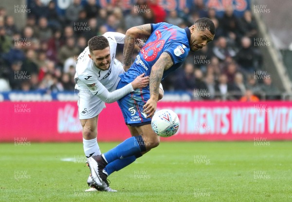 020319 - Swansea City v Bolton Wanderers, Sky Bet Championship - Josh Magennis of Bolton Wanderers and Matt Grimes of Swansea City compete for the ball