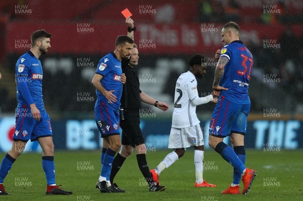 020319 - Swansea City v Bolton Wanderers, Sky Bet Championship - Referee shows the second red card of the match as he sends off David Wheater of Bolton Wanderers