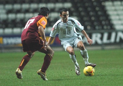 140206 - Swansea City v Bradford City - Swansea's Leon Britton tries to get past Bobby Petta  