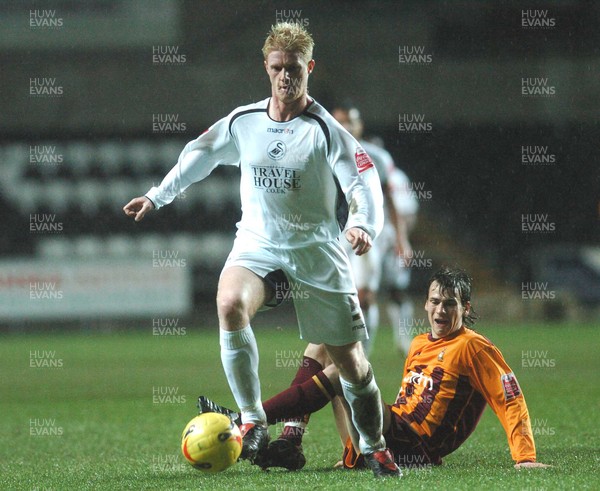 140206 - Swansea City v Bradford City - Swansea's Alan Tate gets past Mark Bower  