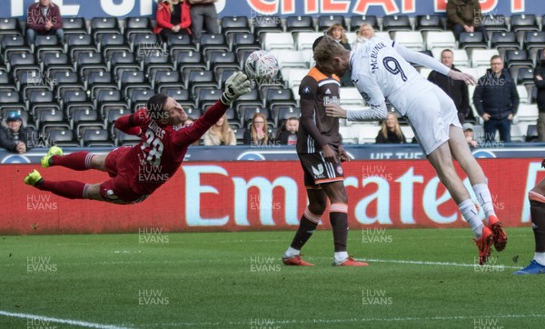 170219 - Swansea City v Brentford, FA Cup Fifth Round - Oli McBurnie of Swansea City looks to head as Brentford goalkeeper Luke Daniels dives for the ball