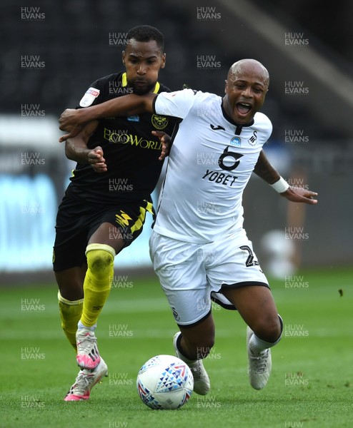 260720 - Swansea City v Brentford - EFL SkyBet Championship Play-Off - Andre Ayew of Swansea City is tackled by Rico Henry of Brentford