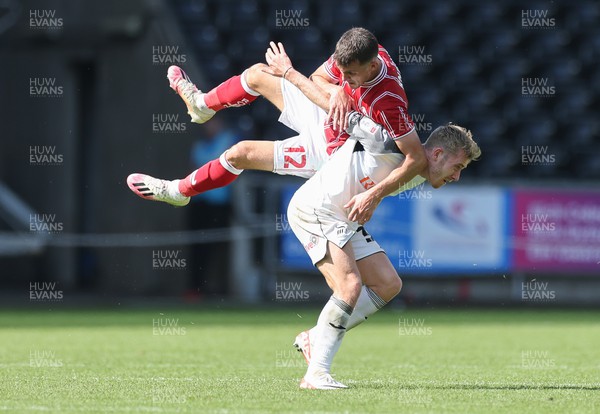 020923 - Swansea City v Bristol City, Sky Bet Championship - Jason Knight of Bristol City hitches a ride on the back on Ollie Cooper of Swansea City after they compete for the ball