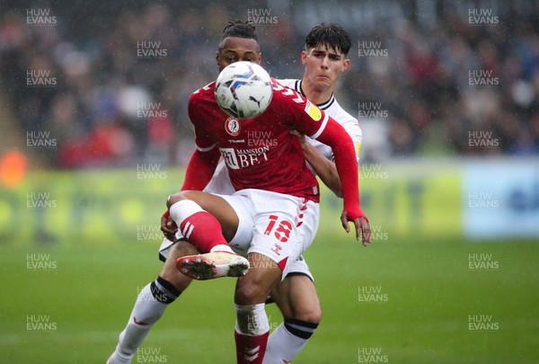 130222 - Swansea City v Bristol City, Sky Bet Championship - Antoine Semenyo of Bristol City keeps his eyes on the ball as Finley Burns of Swansea City challenges