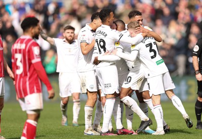 190323 - Swansea City v Bristol City, EFL Sky Bet Championship - Team mates celebrate with Olivier Ntcham of Swansea City after he scores Swansea’s second goal