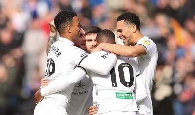 190323 - Swansea City v Bristol City, EFL Sky Bet Championship - Team mates celebrate with Olivier Ntcham of Swansea City after he scores Swansea’s second goal