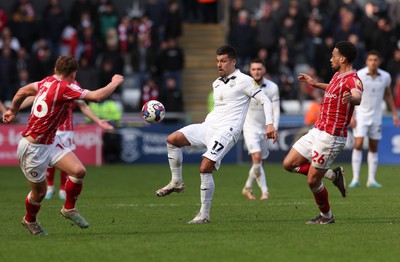 190323 - Swansea City v Bristol City, EFL Sky Bet Championship - Joel Piroe of Swansea City plays the ball as Zak Vyner of Bristol City  challenges