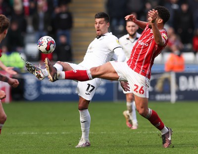 190323 - Swansea City v Bristol City, EFL Sky Bet Championship - Joel Piroe of Swansea City plays the ball as Zak Vyner of Bristol City  challenges