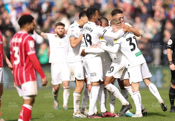 190323 - Swansea City v Bristol City, EFL Sky Bet Championship - Team mates celebrate with Olivier Ntcham of Swansea City after he scores Swansea’s second goal