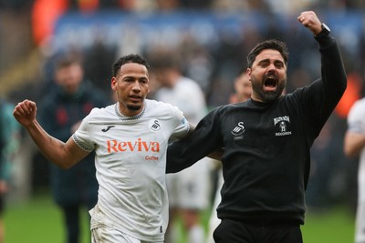 210226 - Swansea City v Bristol City - Sky Bet Championship - Ronald of Swansea City (L) and Vitor Matos Swansea City Manager (R) celebrate at full-time