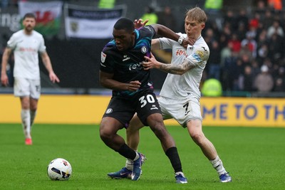 210226 - Swansea City v Bristol City - Sky Bet Championship - Melker Widell of Swansea City and Sinclair Armstrong of Bristol City battle for the ball