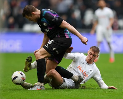 210226 - Swansea City v Bristol City - Sky Bet Championship - Jay Fulton of Swansea City slides in to tackle Rob Atkinson of Bristol City