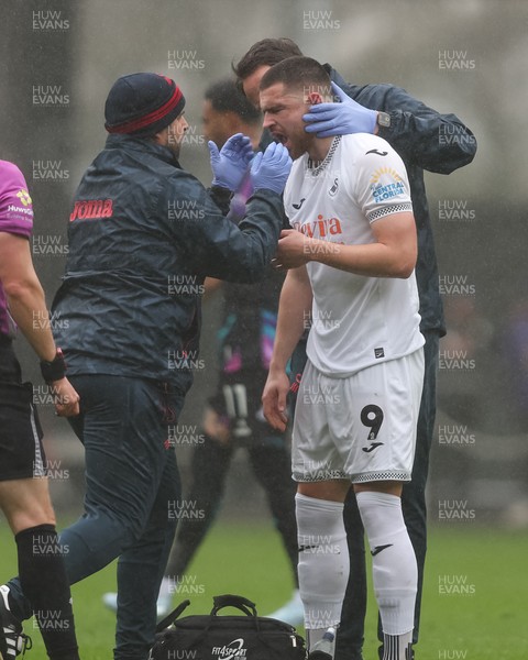 210226 - Swansea City v Bristol City - Sky Bet Championship - Zan Vipotnik of Swansea City is treated for an injury